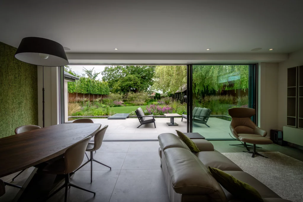 Contemporary garden view framed by sliding glass doors.