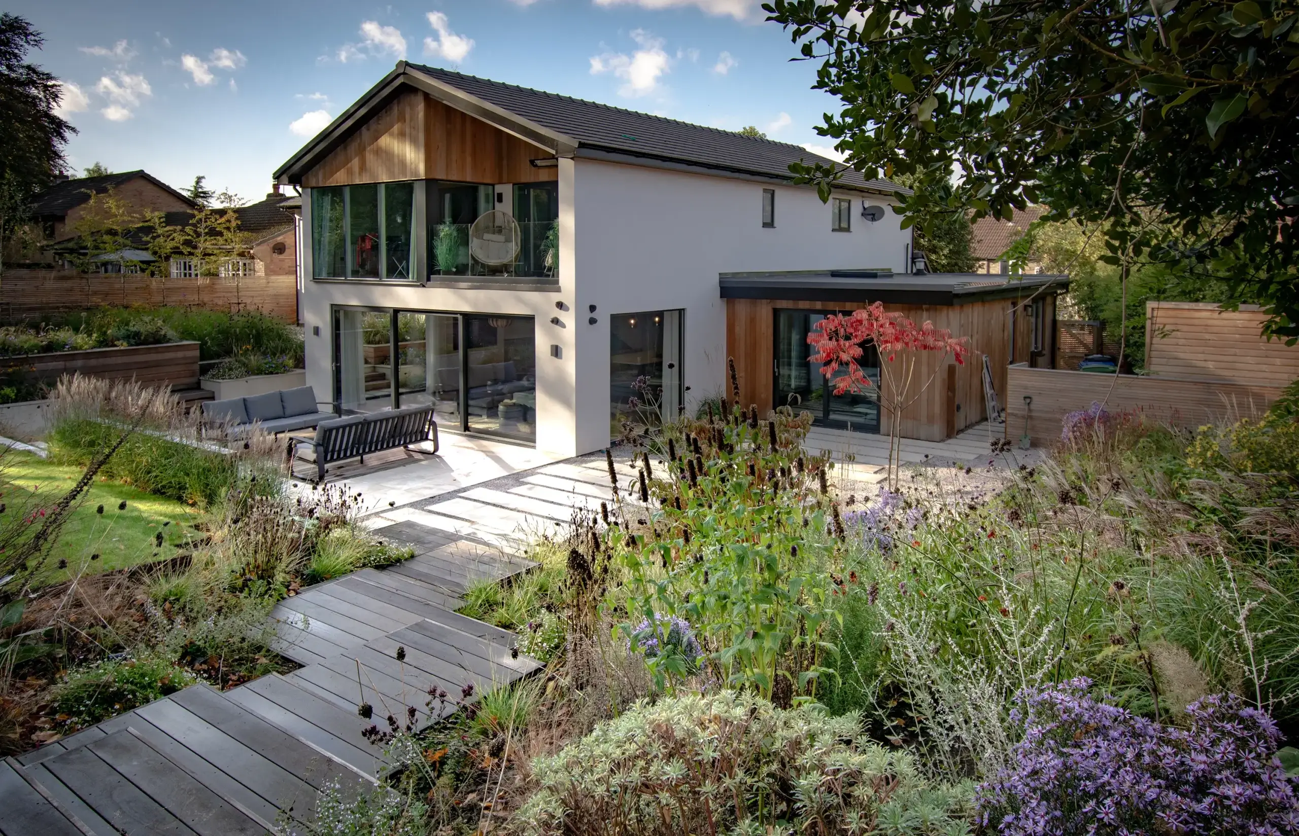 Modern garden with timber pathways and mixed perennial planting.