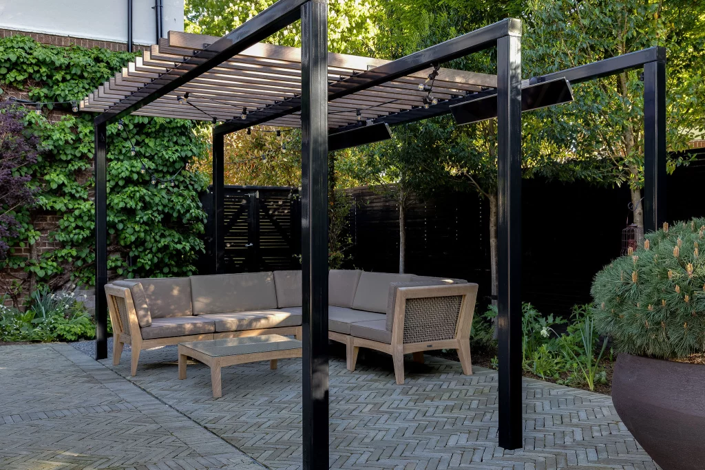 Modern garden seating area under a slatted pergola structure.