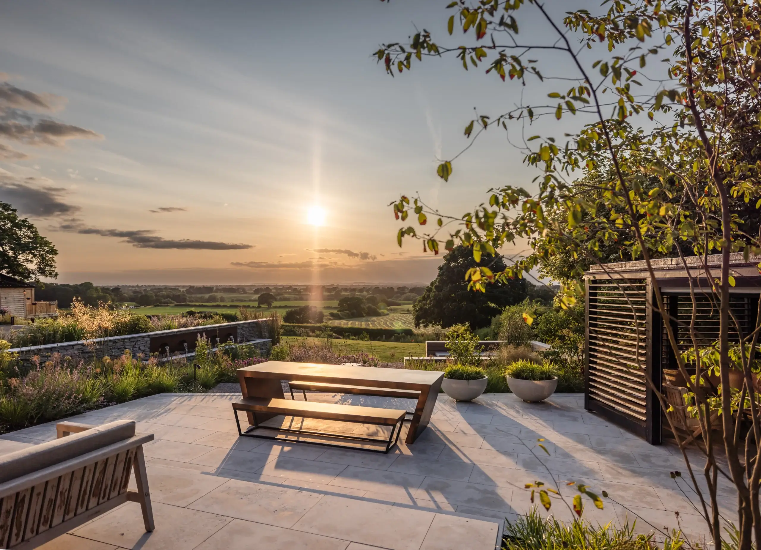 Contemporary garden terrace with seating and panoramic countryside views.