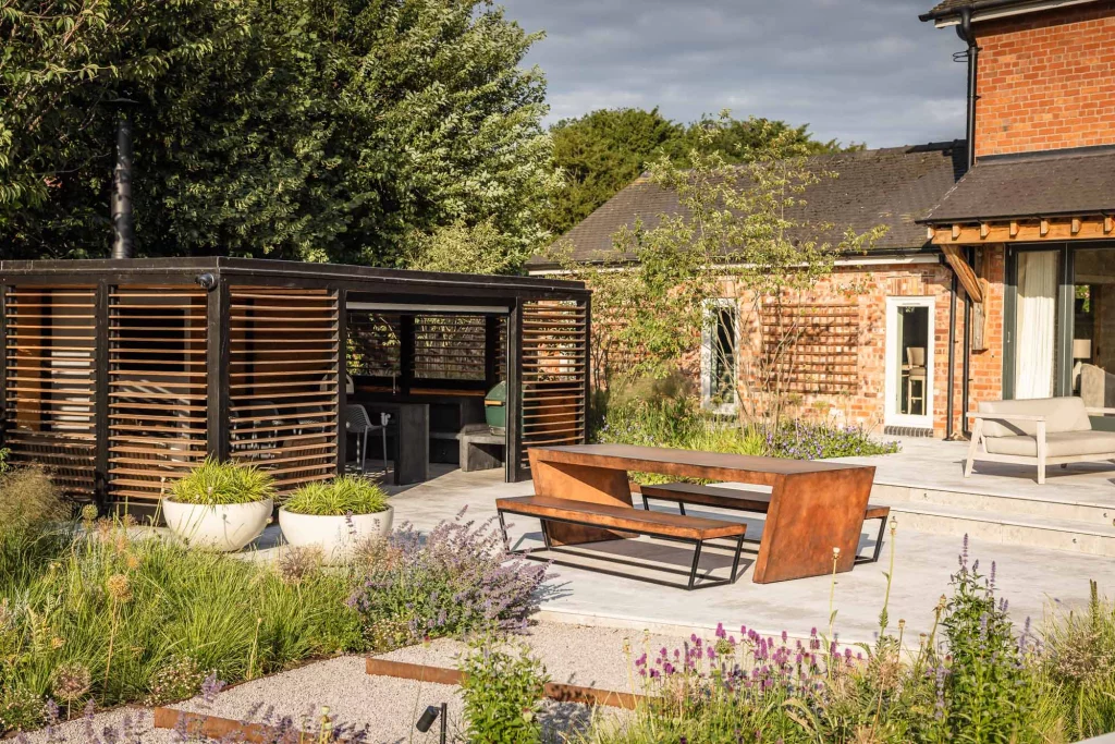 Garden terrace with timber pergola and modern dining area.