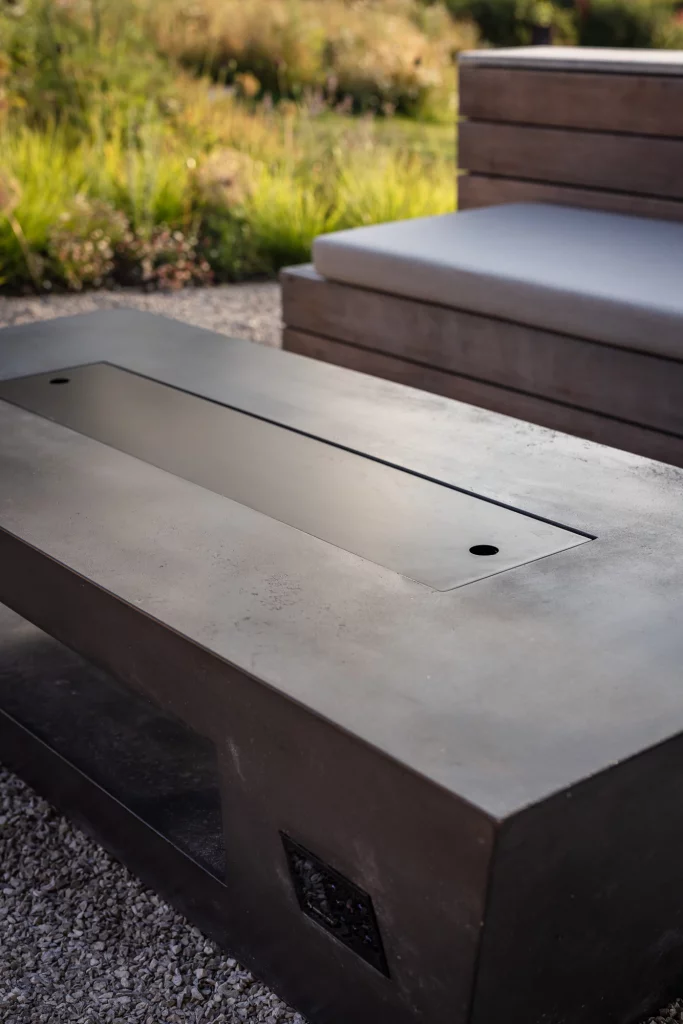 Bespoke garden seating with a sleek built-in fire table.