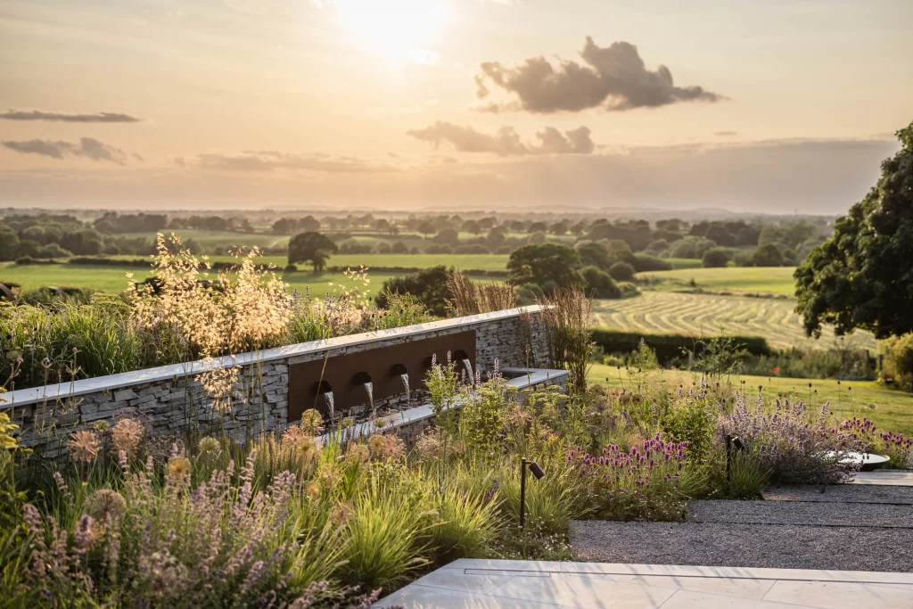 Contemporary garden with layered planting and distant rural views.